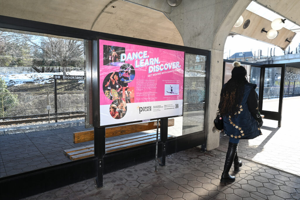 Woman walking by an ad in the Dc Metro.